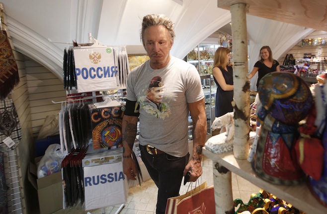Actor Rourke wears a T-shirt with an image depicting Russia's President Vladimir Putin, as he visits a souvenir shop at GUM department store in central Moscow