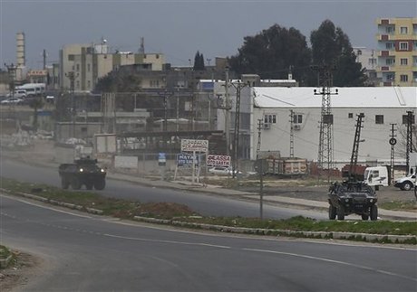 Turkish forces' armoured vehicles patrol at the southeastern town of Nusaybin, Turkey, near the border with Syria, where Turkish security forces are battling militants linked to the outlawed Kurdistan Workers, Party or PKK, Sunday, Feb. 14, 2016, a day after Turkish media reports said a police officer was injured in a clash. The private Dogan news agency said the militants on Saturday detonated an explosive device in the town as a military vehicle was passing by, but no one injured. A second bomb was defused in a controlled explosion. (AP Photo/Lefteris Pitarakis)