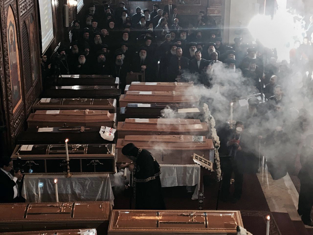 Coffins are laid out during a funeral service for victims of a Sunday cathedral bombing, at the Virgin Mary Church, in Cairo, Egypt, Monday, Dec. 12, 2016. Egyptians held prayers for 25 Christians killed the day before at a church next to the city's main Coptic cathedral in what was one of the deadliest attacks on the religious minority in recent memory. The bomb went off while worshippers were attending Sunday Mass at a chapel adjacent to St. Mark's Cathedral. The coffins of the 25 have been laid in front of the altar, with the names of each victim plastered on the side facing the congregation. (AP Photo/Nariman El-Mofty)